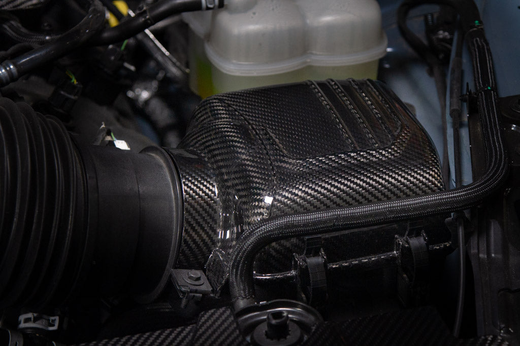 Carbon fiber intake box top cover in Mustang Dark Horse engine bay