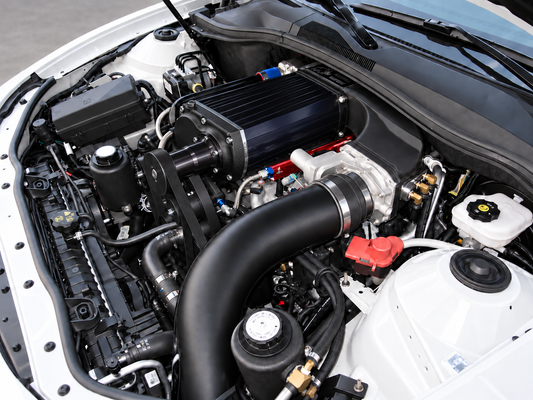 AI illustration of black Kenne Bell Mammoth style supercharger installation in a white 2010–2014 Chevrolet Camaro; actual configuration varies
